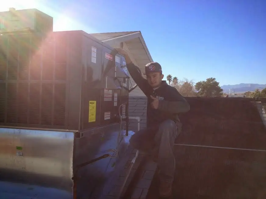 HVAC technician performing HVAC Inspection on a rooftop unit in Laguna Woods